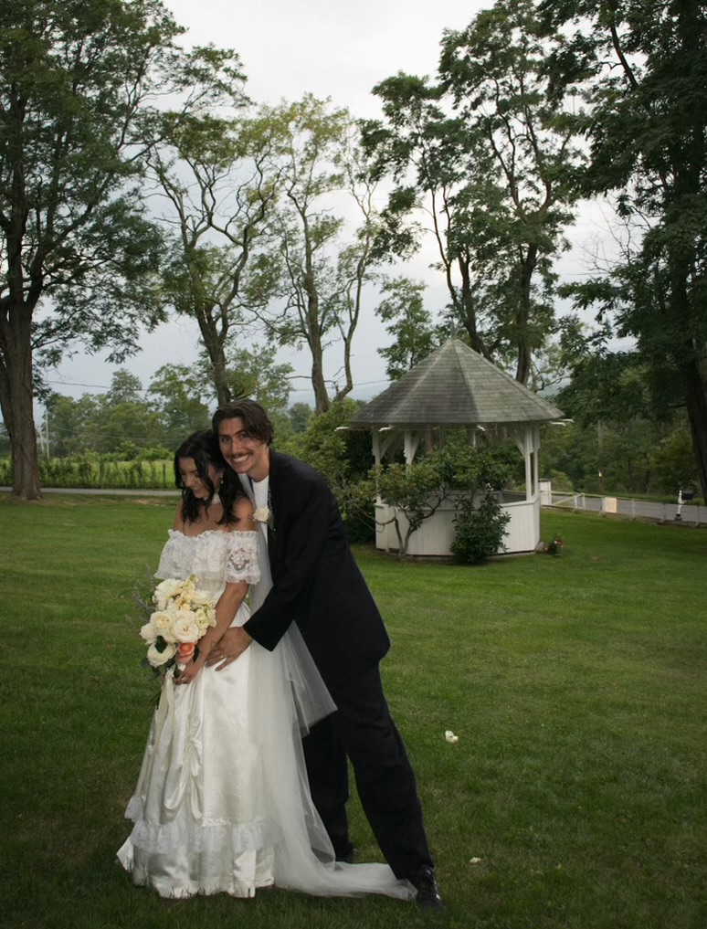 Newlyweds on the lawn beside the gazebo