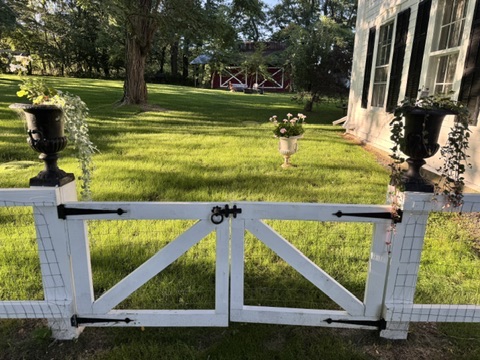 White garden gate opening onto the lawn