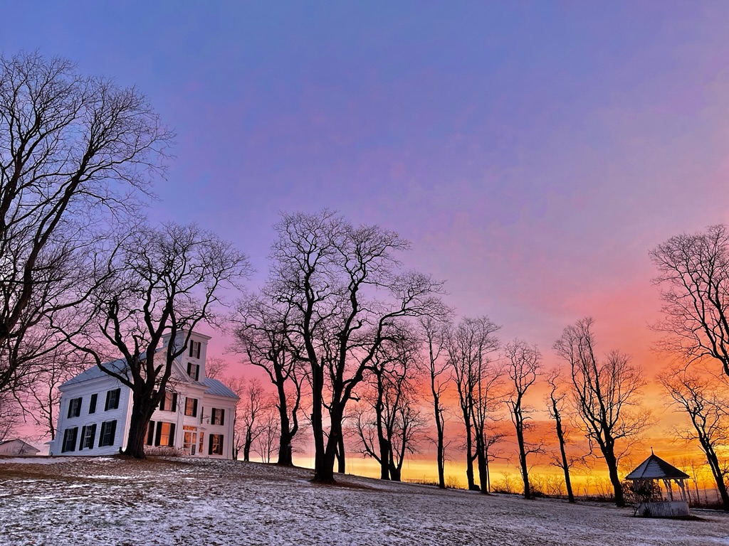 Winter sunset behind the house and gazebo