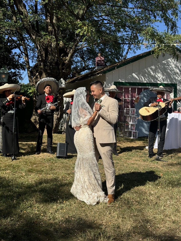 An outdoor wedding dance with musicians