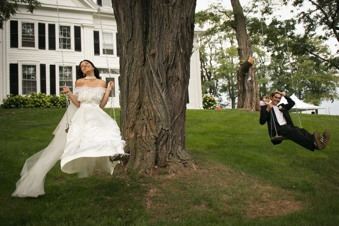 A wedding couple enjoying the tree swings outside Durham White House