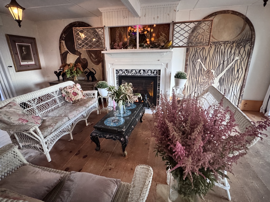 Wicker seating around the tiled gathering-room fireplace