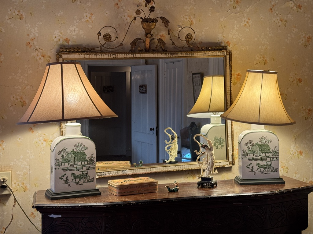Antique dresser with paired lamps and a mirror