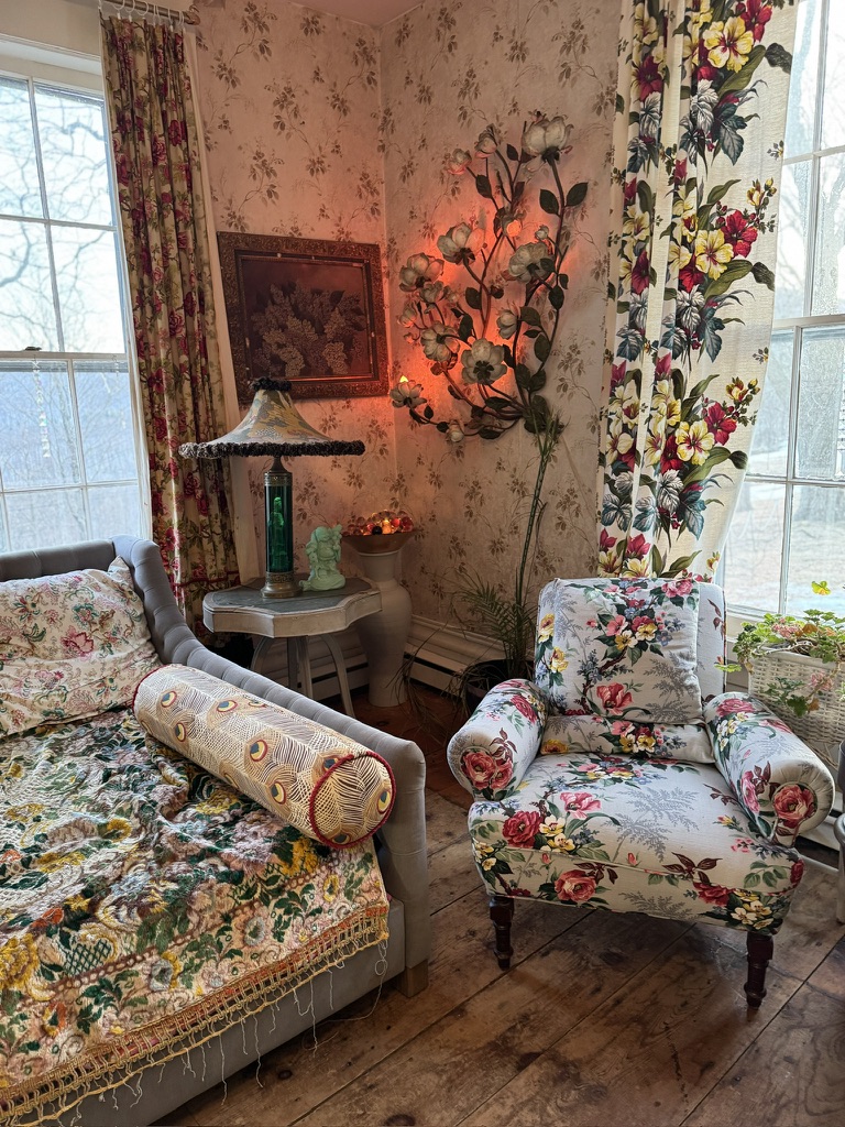 Floral armchairs beside the sitting-room window