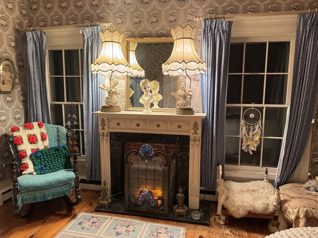 Fireplace with decorative lamps and blue curtains