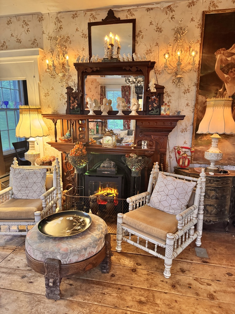 Sitting room with antique chairs and a fireplace