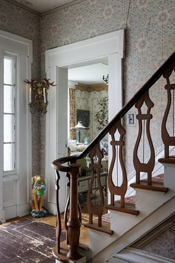 Entry hall and curved wooden staircase