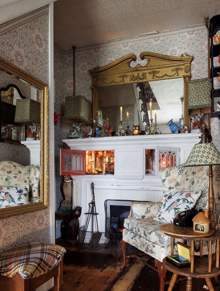 White fireplace and antique furnishings