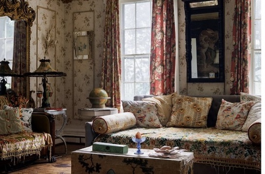 Floral sofa beneath tall windows
