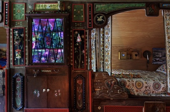 Stained-glass details beside a carved wooden bed