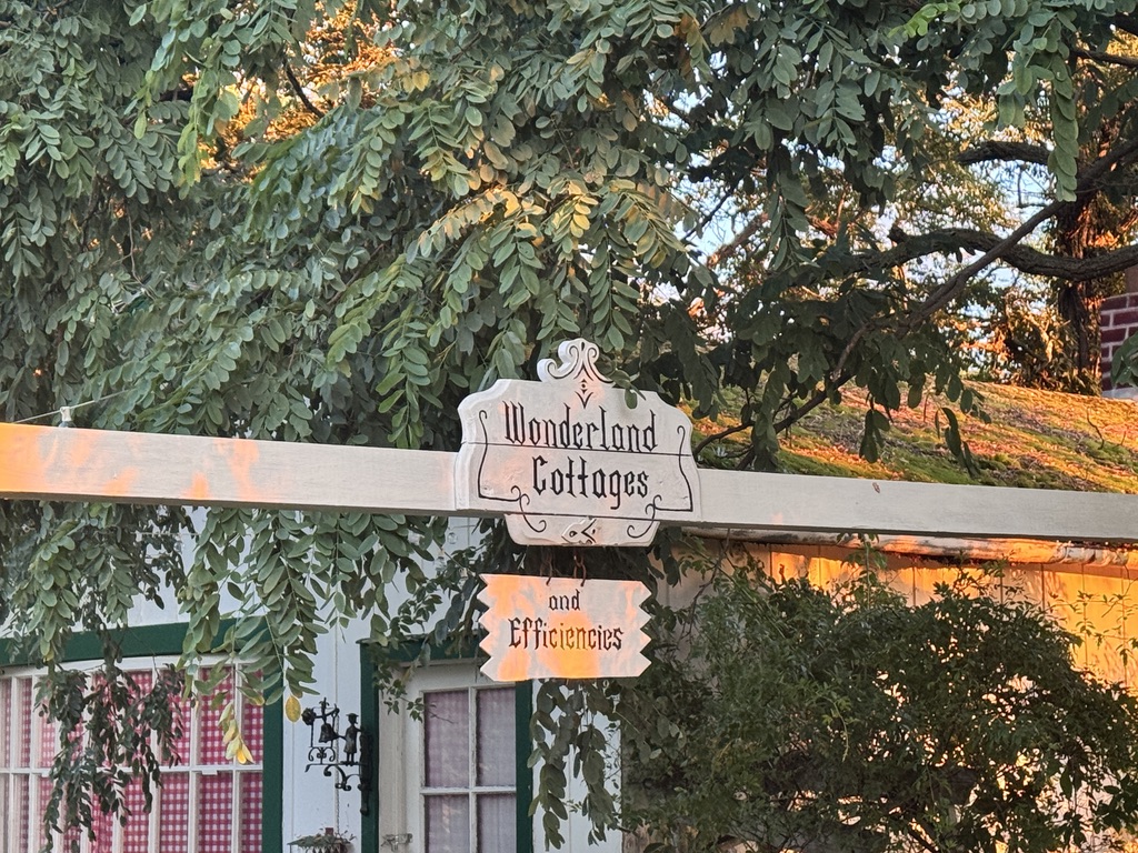 Wonderland Cottages sign beneath the trees