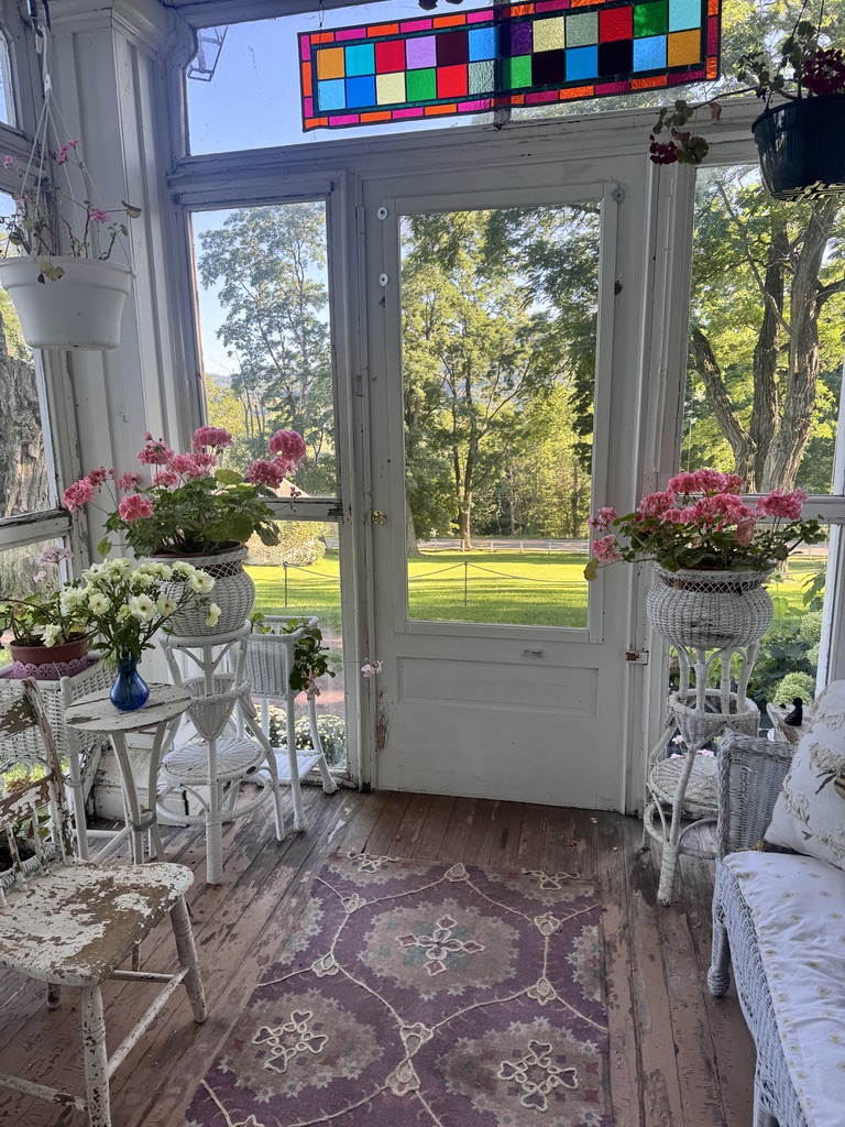 Sunlit porch with stained glass and flowers
