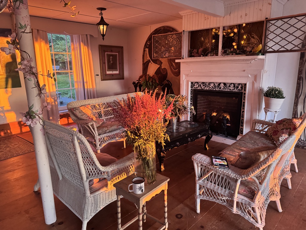 Gathering room fireplace and wicker seating at sunset