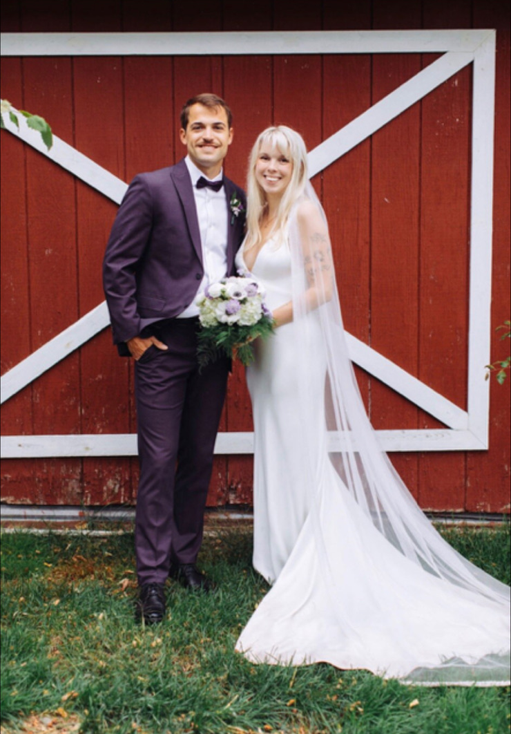 Wedding portrait in front of the red barn doors