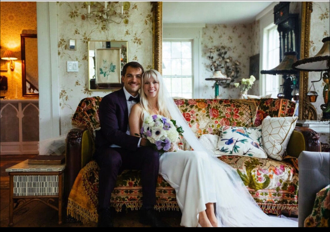 Newlyweds seated together in the sitting room