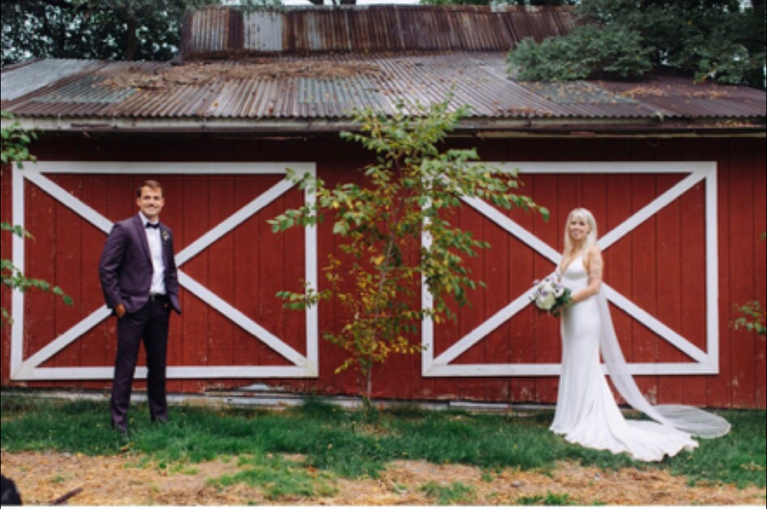 Bride and groom outside the red barn